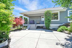 Rear view of property featuring a porch and roof with shingles