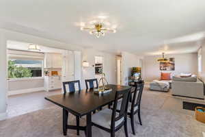 Dining room featuring a chandelier and light carpet