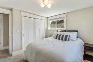 Bedroom with carpet and a closet