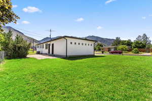 View of front of home with a mountain view and a patio