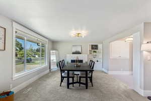 Dining room featuring light carpet and built in shelves