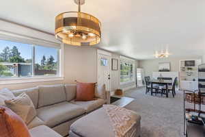 Living room featuring a chandelier and carpet