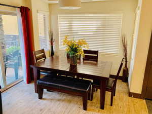 Dining area featuring light wood-style flooring and baseboards
