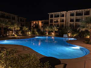 Pool at twilight with a community pool and a patio area