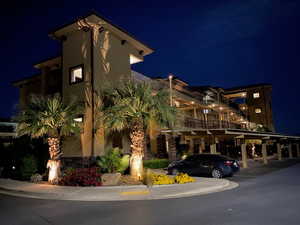 Property at twilight with covered parking