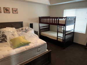 Bedroom with carpet floors and baseboards