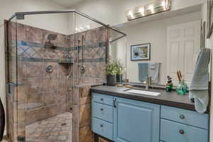 Bathroom with vanity and a shower stall