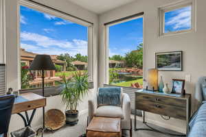 Sitting room featuring carpet flooring and baseboards