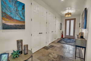 Entrance foyer with stone tile floors