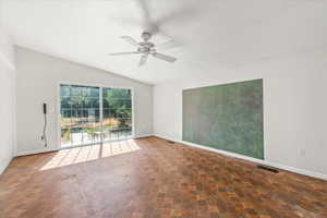 Unfurnished room featuring ceiling fan and lofted ceiling