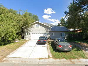 View of front of house with driveway and a garage