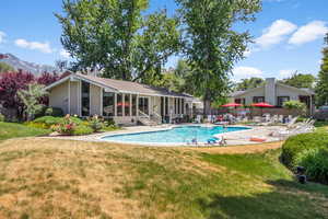 Community pool with a patio area and a mountain view
