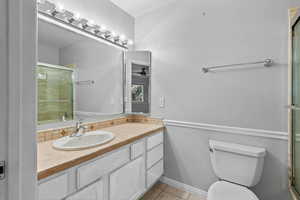 Bathroom featuring vanity, light tile patterned floors, a shower stall, and ceiling fan