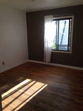 Empty room featuring wood finished floors