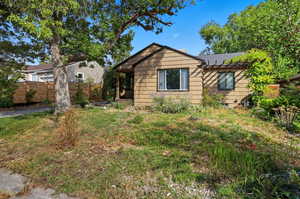View of side of property featuring a shingled roof