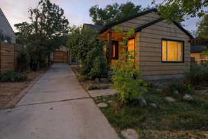 Property exterior at dusk with driveway and a garage