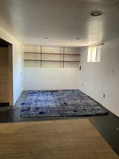 Spare room with unfinished concrete flooring