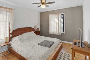 Bedroom featuring light wood finished floors and a ceiling fan
