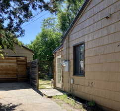 View of property exterior with a gate and a garage