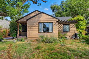 View of front of property with a shingled roof