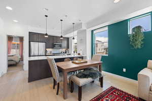 Dining room with recessed lighting and light wood-type flooring