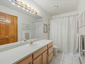 Bathroom with tile patterned floors and vanity