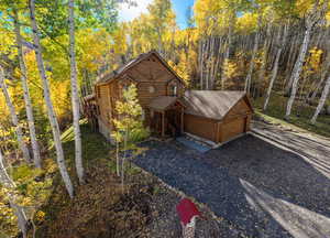 View of front facade and a wooded view