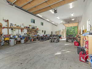 8 Car heated garage featuring a workshop