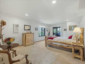 Bedroom featuring light carpet and recessed lighting