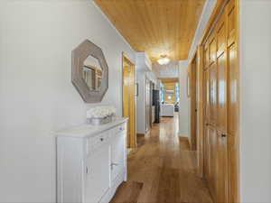Hall with wooden ceiling and light wood-type flooring