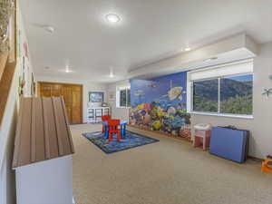 Recreation room with carpet flooring and recessed lighting