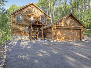 View of front of house with an outdoor structure and a garage