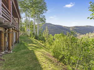 View of green lawn featuring a mountain view