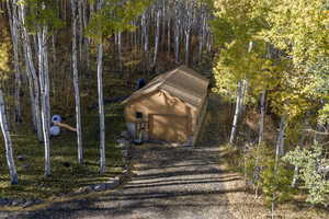 Exterior space featuring a garage and gravel driveway