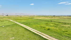 View of yard with a rural view and a mountain view