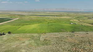 Aerial view of property and surrounding area featuring a mountain backdrop