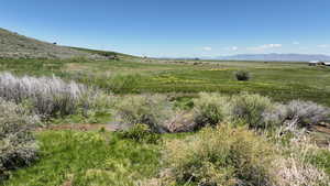 View of mountain backdrop with rural landscape