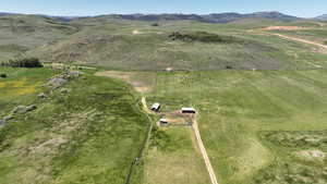 Aerial overview of property's location with a mountain backdrop and rural landscape