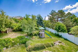 Fenced backyard with a playground