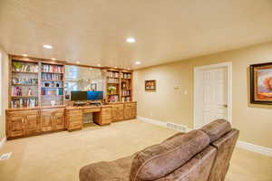 Office with light colored carpet, recessed lighting, and a textured ceiling