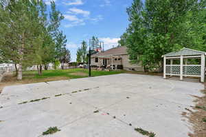 View of patio featuring basketball hoop and a gazebo