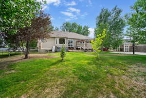 View of yard with a deck and a trampoline