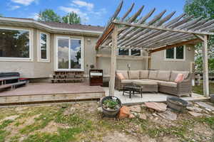 View of patio with an outdoor living space, a deck, and a pergola
