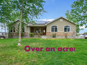 Ranch-style house featuring stone siding and stucco siding
