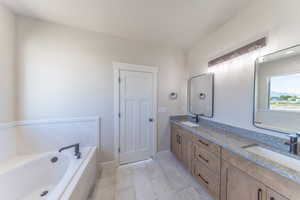 Full bathroom featuring double vanity and a garden tub