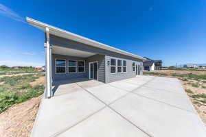 Rear view of house featuring a patio