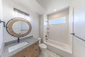 Bathroom with vanity, shower / bath combination, and recessed lighting