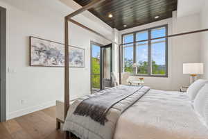 Bedroom featuring wood finished floors, access to outside, multiple windows, and recessed lighting