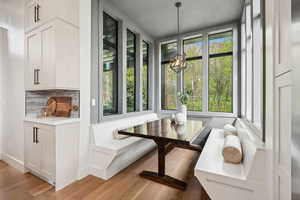 Dining area with a chandelier and light wood-type flooring