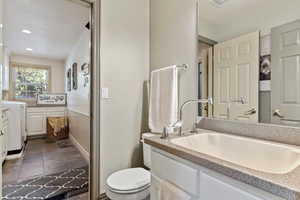 Bathroom with vanity, stone finish floors, recessed lighting, and washer / dryer